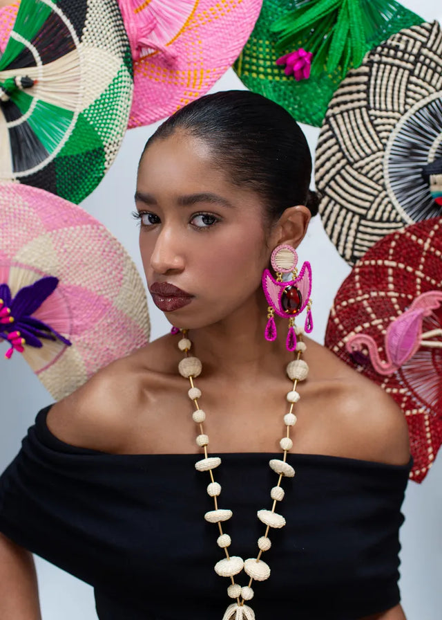 Aretes Rosal de Mercedes Salazar en uso, joyería artesanal colombiana en rafia con cristales